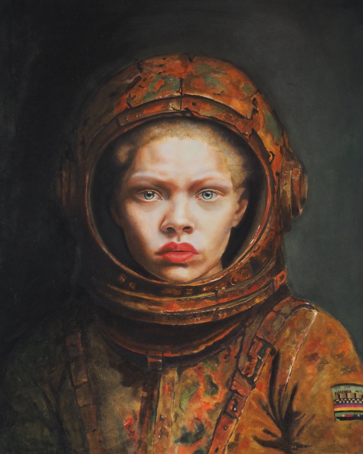 Young child wearing a worn orange astronaut helmet and suit against a dark background